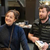 Two event attendees arriving at event and chatting with Kyle Barnhart